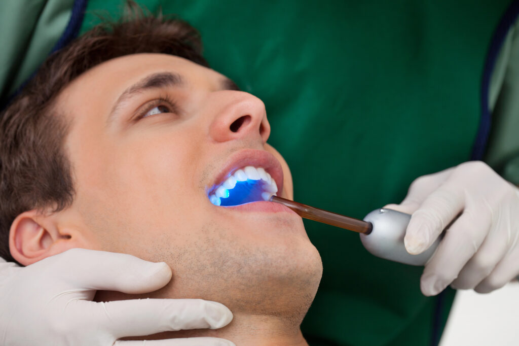 Patient receiving teeth whitening treatment cosmetic dentistry in Panama City, FL