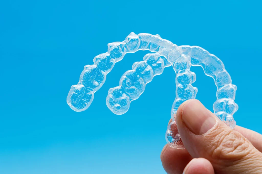 Invisalign in Panama City FL on a blue background.