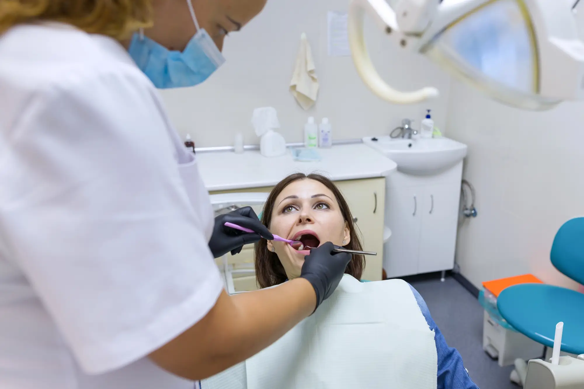 Best dentist near me 32444 treating woman’s teeth at clinic
