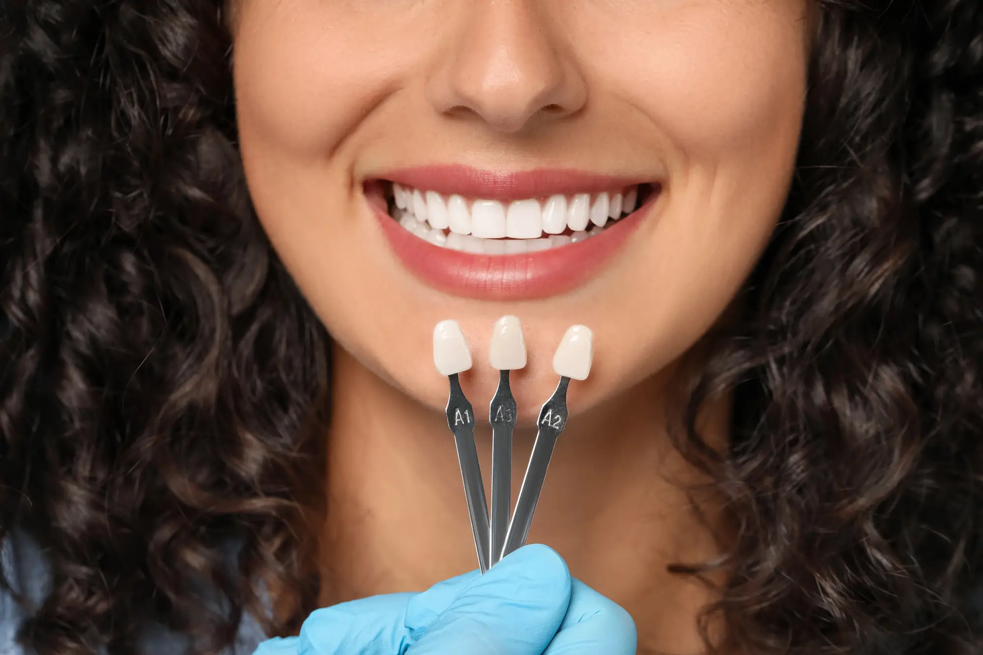 Dentist checking tooth shade for dental fillings panama city fl